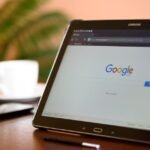 Samsung tablet on desk showing Google homepage, perfect for technology-related content.