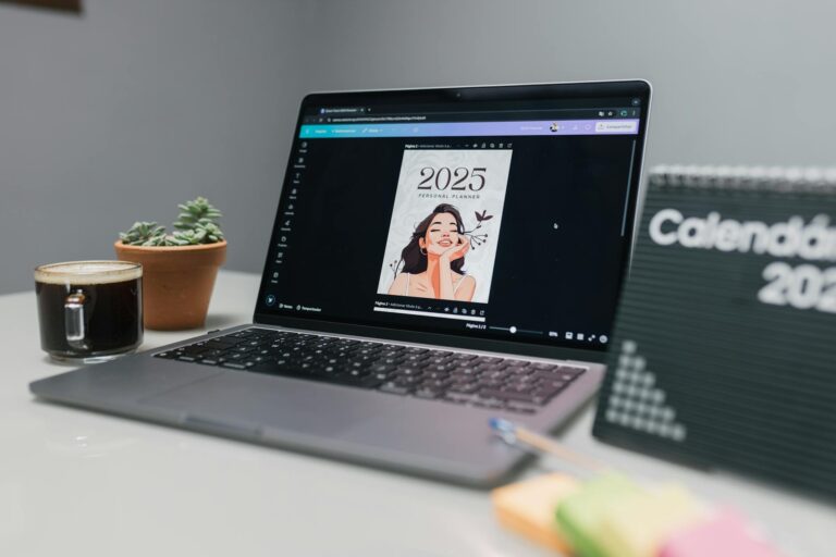 Cozy workspace featuring a laptop with 2025 planner, succulent, coffee, and calendar.