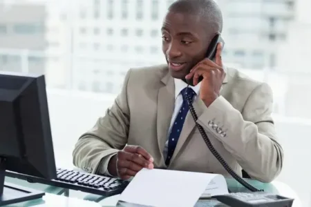 depositphotos 10337958 stock photo smiling entrepreneur making a phone