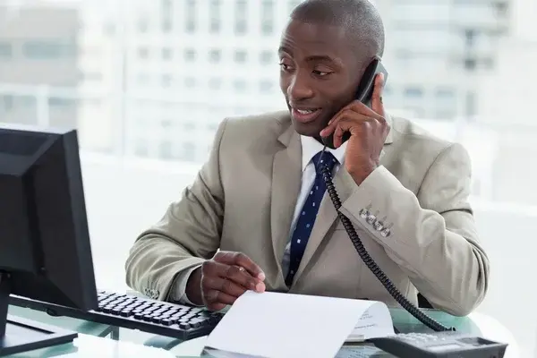 depositphotos 10337958 stock photo smiling entrepreneur making a phone