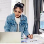 portrait smiling happy beautiful asian woman relaxing using technology laptop computer while sitting tableyoung creative girl working typing keyboard homework home concept 38019 2796