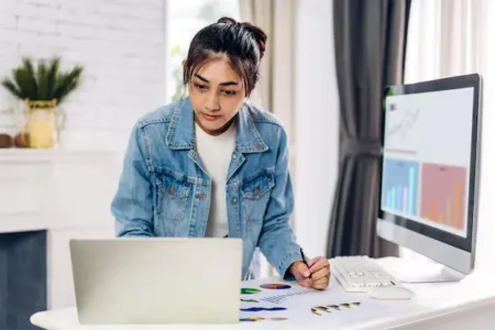 portrait smiling happy beautiful asian woman relaxing using technology laptop computer while sitting tableyoung creative girl working typing keyboard homework home concept 38019 2796
