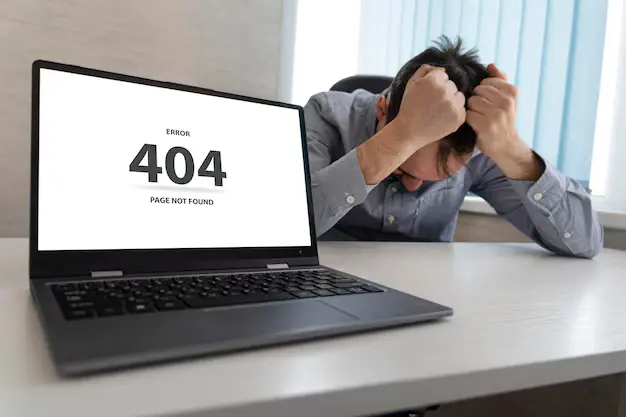 A person sitting in front of a computer screen showing “404 Page Not Found” error with a confused look.